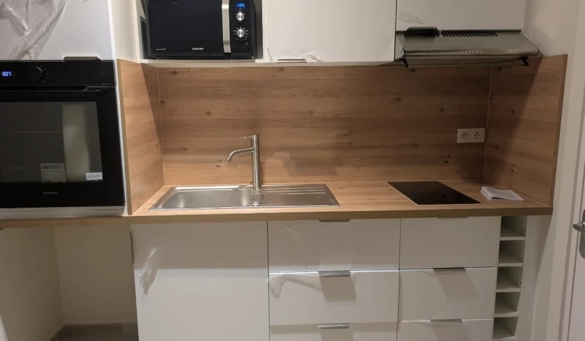 Cuisine rénovée à La Rochelle avec meubles sur mesure, verrière atelier et finitions soignées.