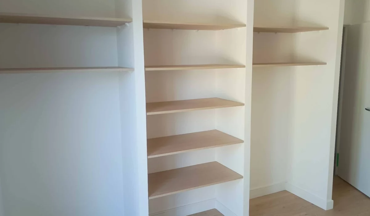Dressing sur mesure réalisé à La Rochelle avec aménagement intérieur, penderies et étagères par ACORENOV.